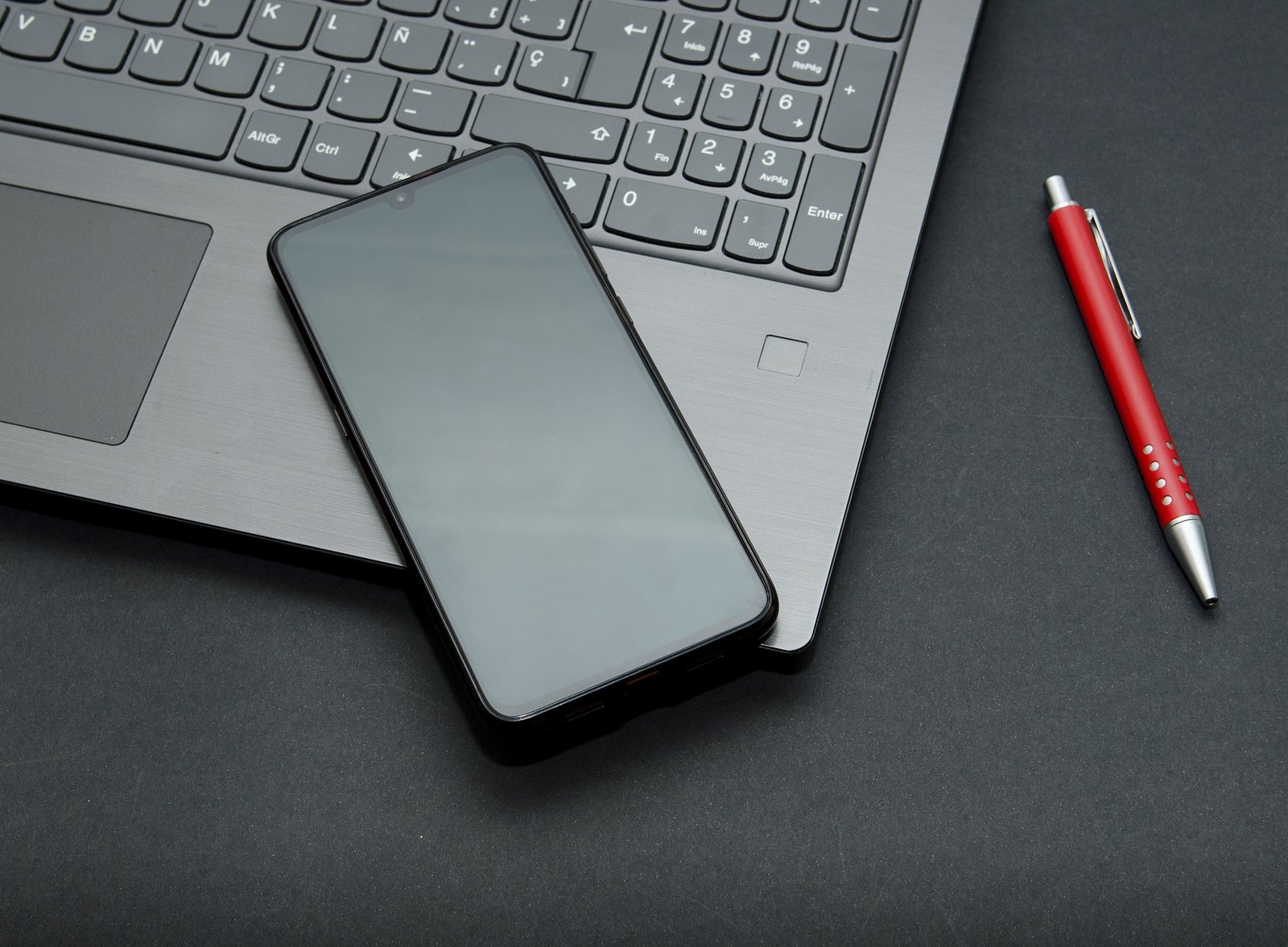 Laptop with smart phone, glasses and pen for working